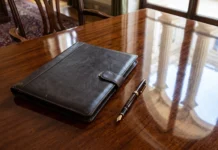 Letitia James to Lead Cornell Rape Probe as Renee Good Family Sues Federal Officials A leather legal folder and pen on a wooden desk representing formal judicial proceedings.