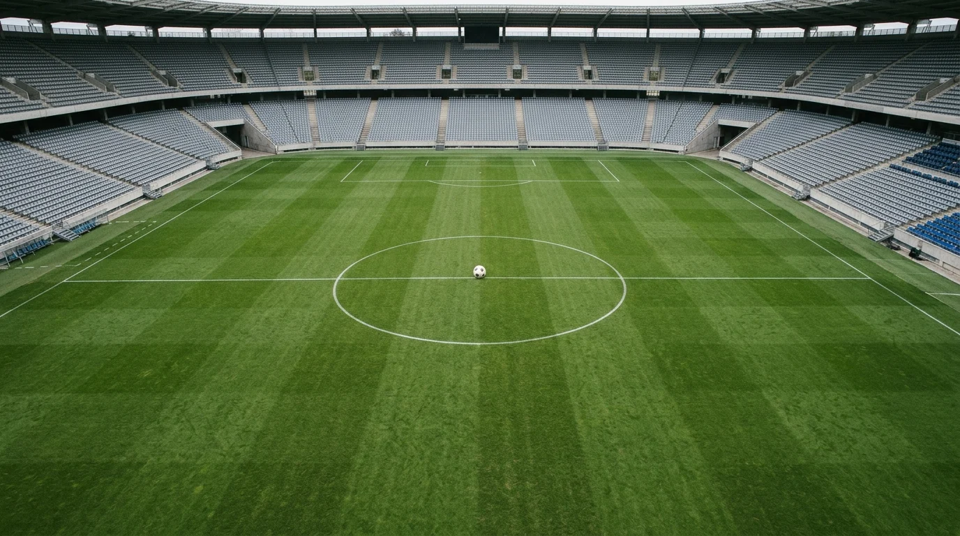 A football centered in the middle of a grass pitch.